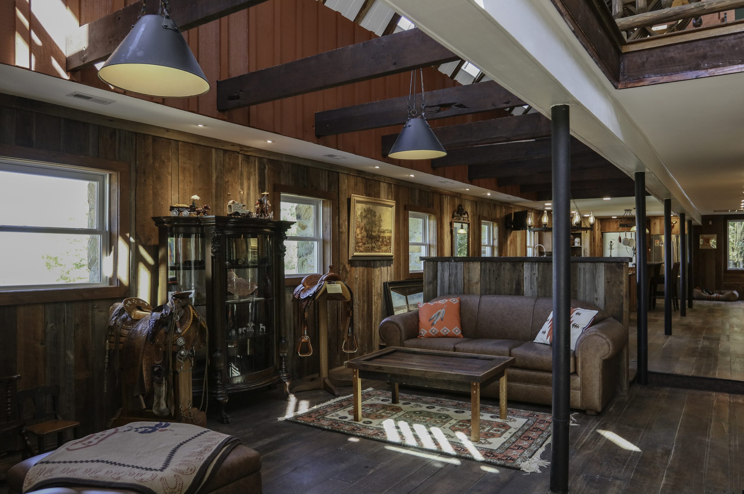 renovated living room with wood-paneled walls and western ranch theme