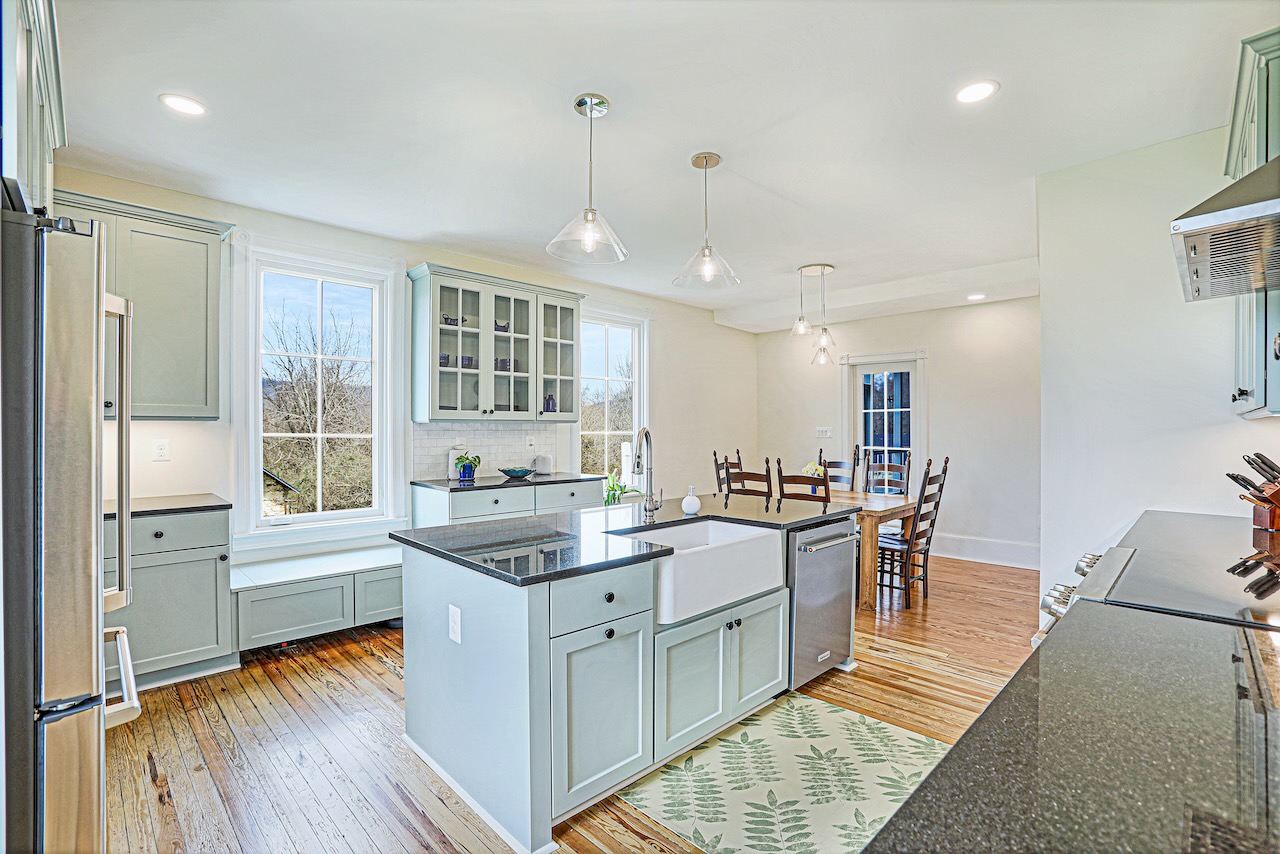 renovated kitchen with hardwood floors and center island with ceramic farmhouse sink