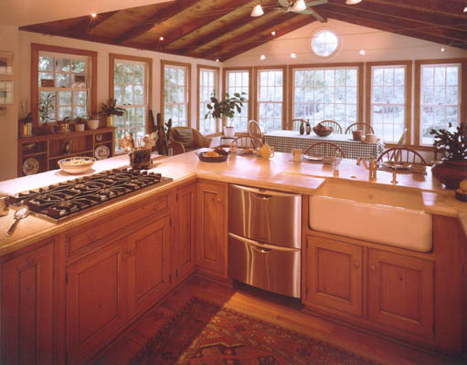 renovated kitchen with exposed beams and windows across every wall