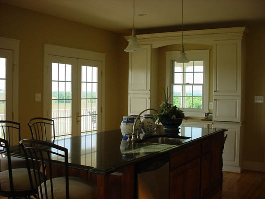 renovated formal dining area with white built-in cabinets surrounding a window