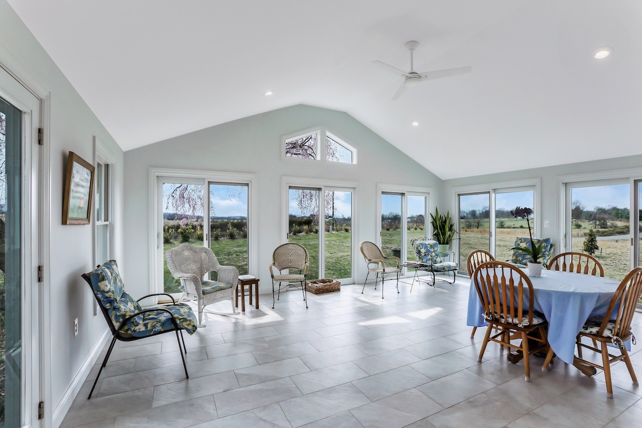 large, bright sunroom with vaulted ceiling