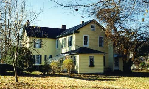 yellow farmhouse before remodel