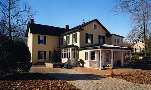 yellow farmhouse after remodel