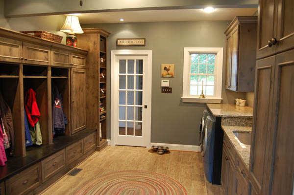 renovated mudroom and laundry room combo with built-in shelving, washer/dryer and sink