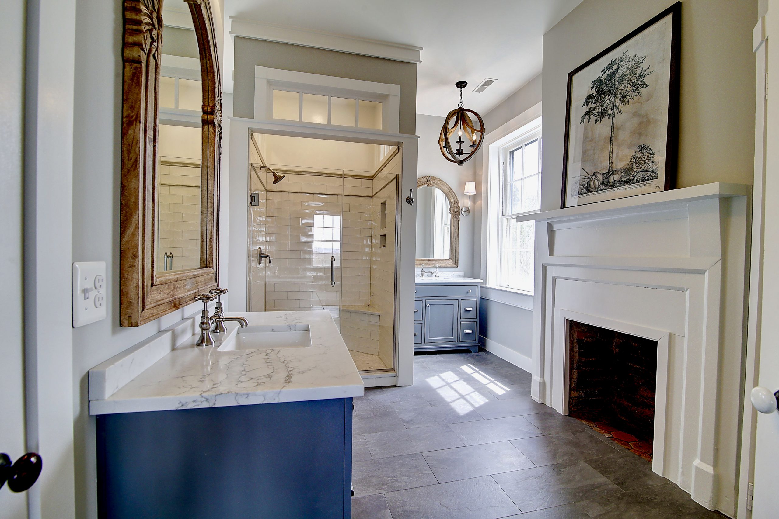 renovated bathroom with fireplace and white mantel