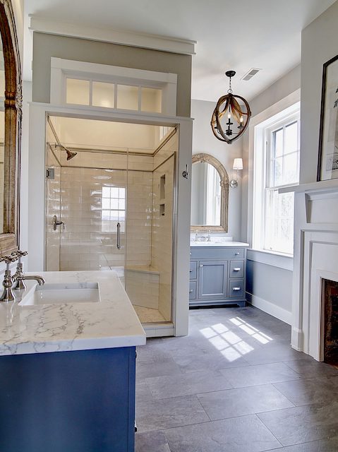 renovated master bathroom with fireplace and enclosed shower