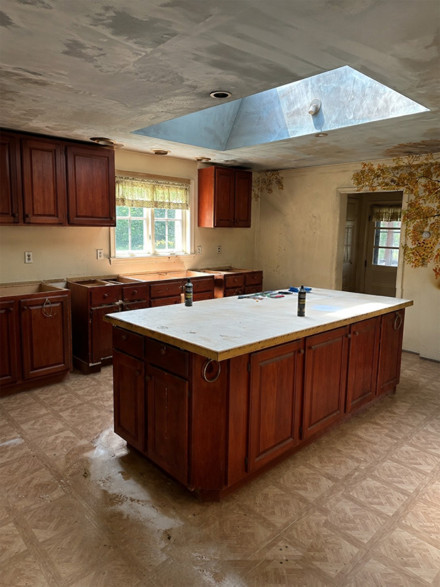 before kitchen murals and cherry red cabinets